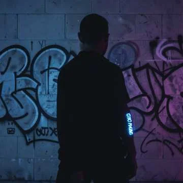 Streetlights paint our shadows on the grey stone wall